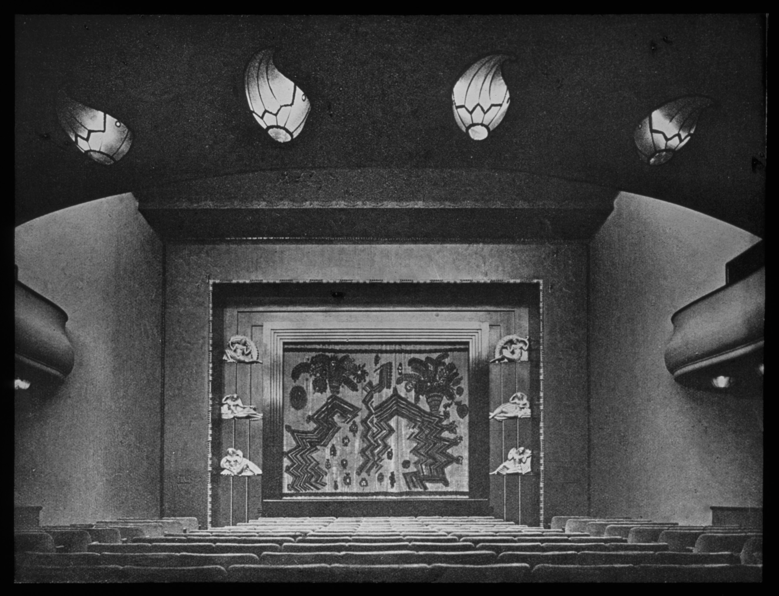 Black and white photo of the auditorium facing the screen.