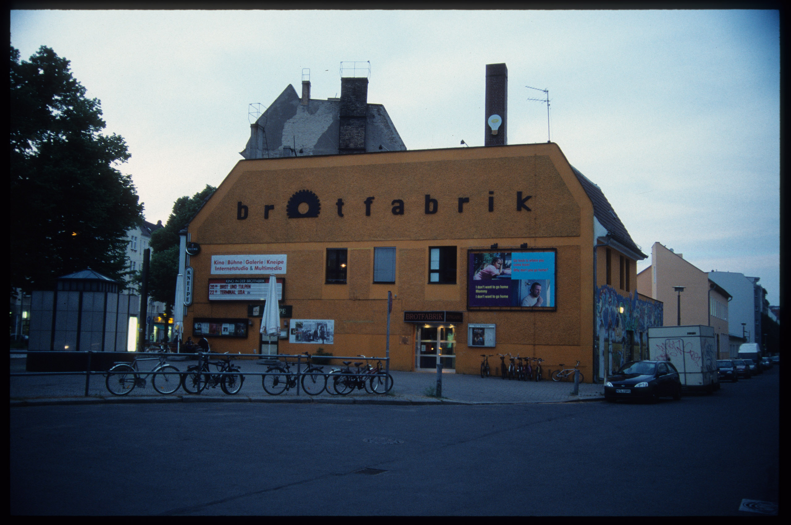 Color photo: façade of the cinema at dawn with lettering