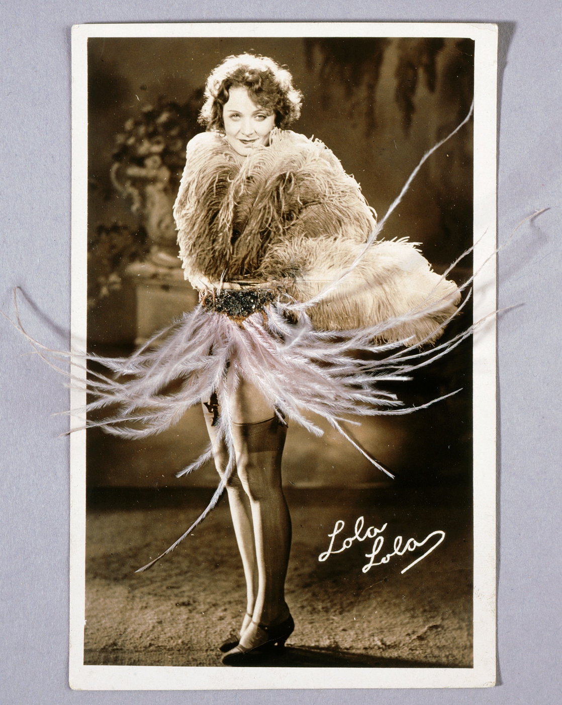 Postcard of Marlene Dietrich with real feathers