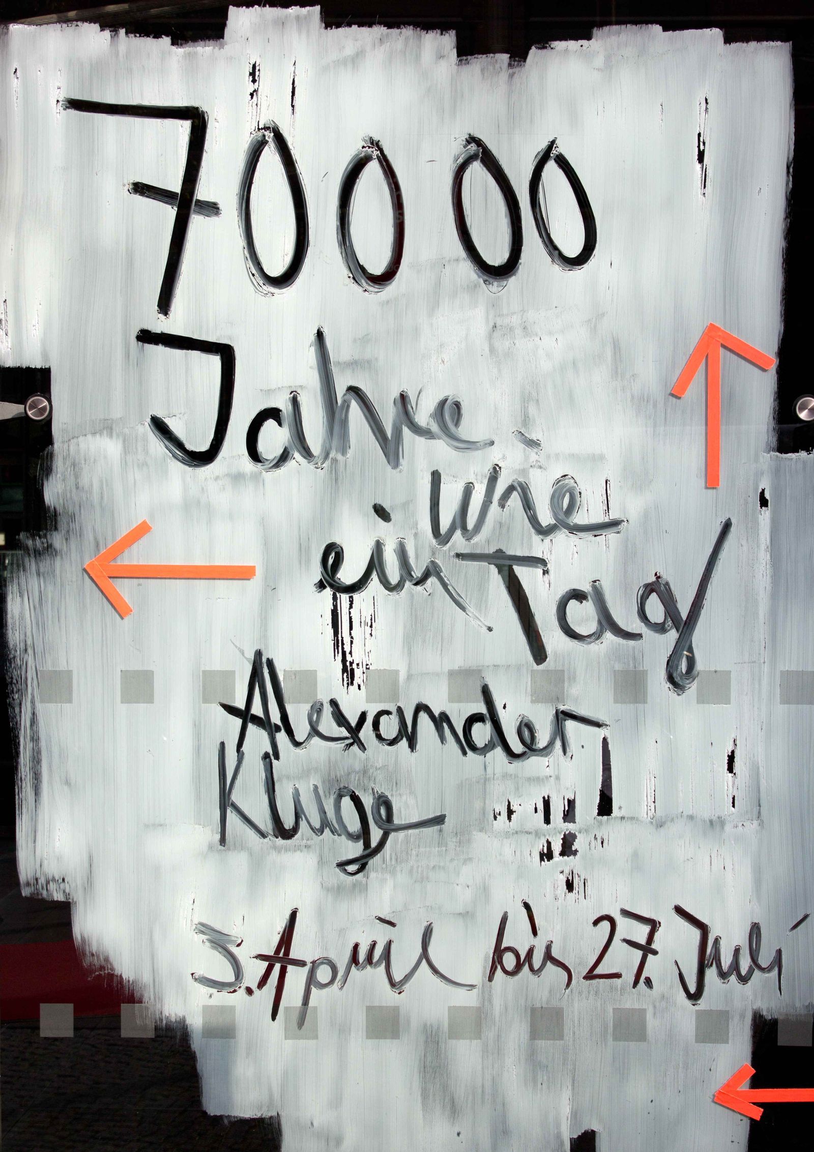 Photo of the exhibition title "70,000 Years Just Like One Day – Alexander Kluge’s Current Work for Television Films, Plus an Installation – A Place of Enchantment", Deutsche Kinemathek, Berlin