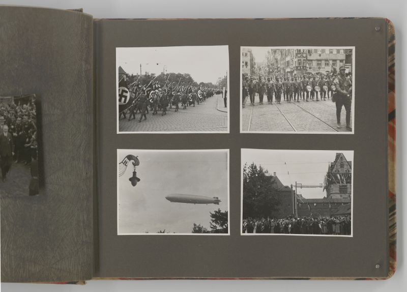 Vier Schwarzweiß-Fotos in einem alten Fotoalbum mit Hakenkreuzfahnen und Zeppelinen