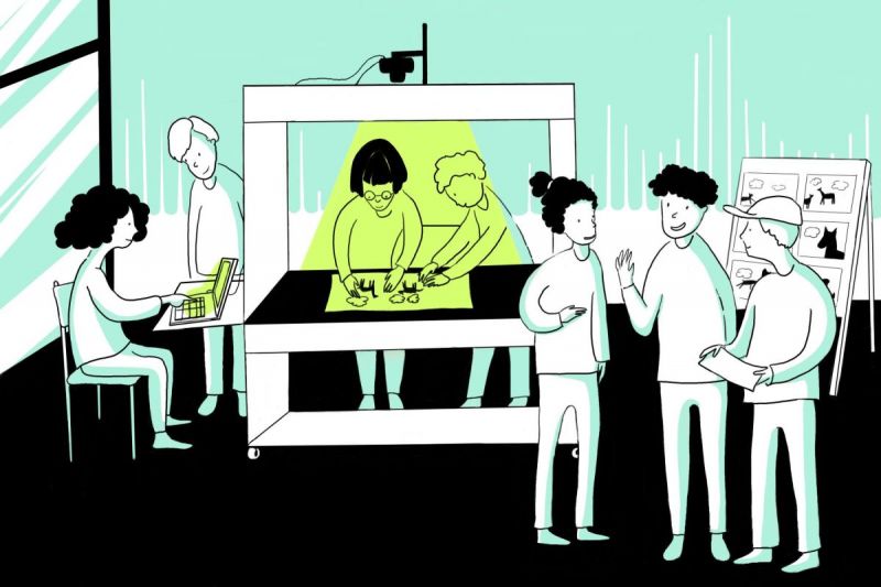 Illustration: Eine Gruppe Kinder steht um eine Trickbox, zwei basteln, zwei sitzen an einem Computer neben der Box und drei stehen davor.