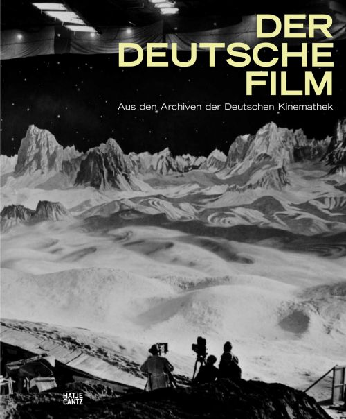 Cover: Schwarz-weiß-Foto eines Filmsets mit Mondlandschaft, im Vordergrund Kameramann und zwei weitere Personen. Oben in gelber Schrift der Titel in gelben Versalien gesetzt