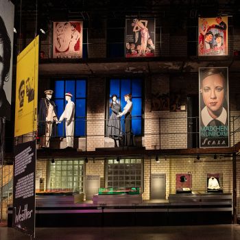 A view of an exhibition wall featuring various film stills.
