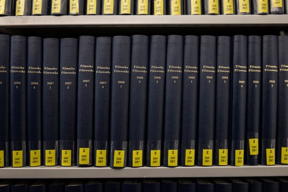 A book series that includes many books is on the shelf in the library.