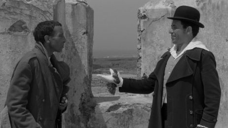 Zwei M&auml;nner stehen auf einer Ruine und unterhalten sich. Der eine reicht dem anderen die Hand.