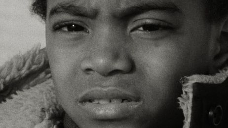 In einer Nahaufnahme ist ein schwarzer Junge mit verzerrtem Gesichtsausdruck zu sehen.