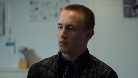 Ein junger Mann blickt nachdenklich und skeptisch nach vorn.